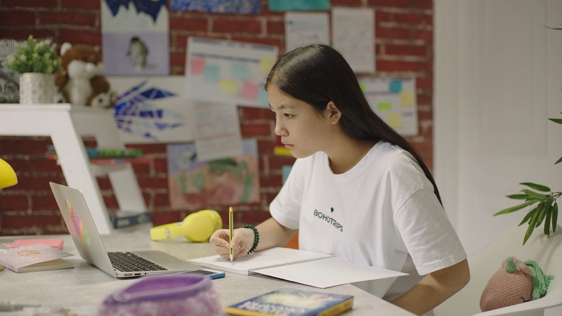 Young girl studying at a colorful desk
