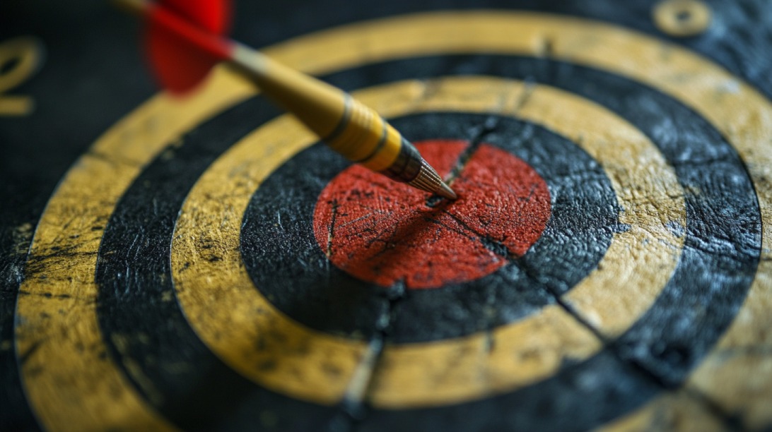 Close-up of a dart hitting the bullseye on a dartboard, symbolizing precision and focus