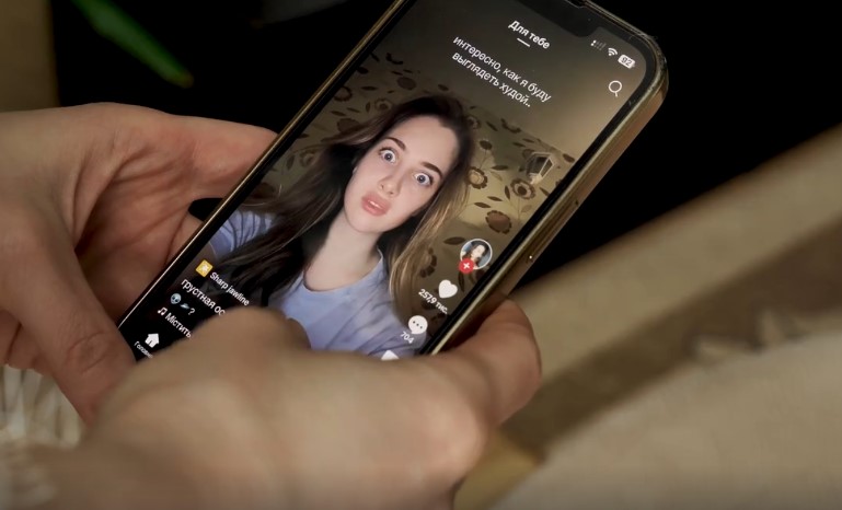A young woman's TikTok video, displaying an exaggerated facial expression